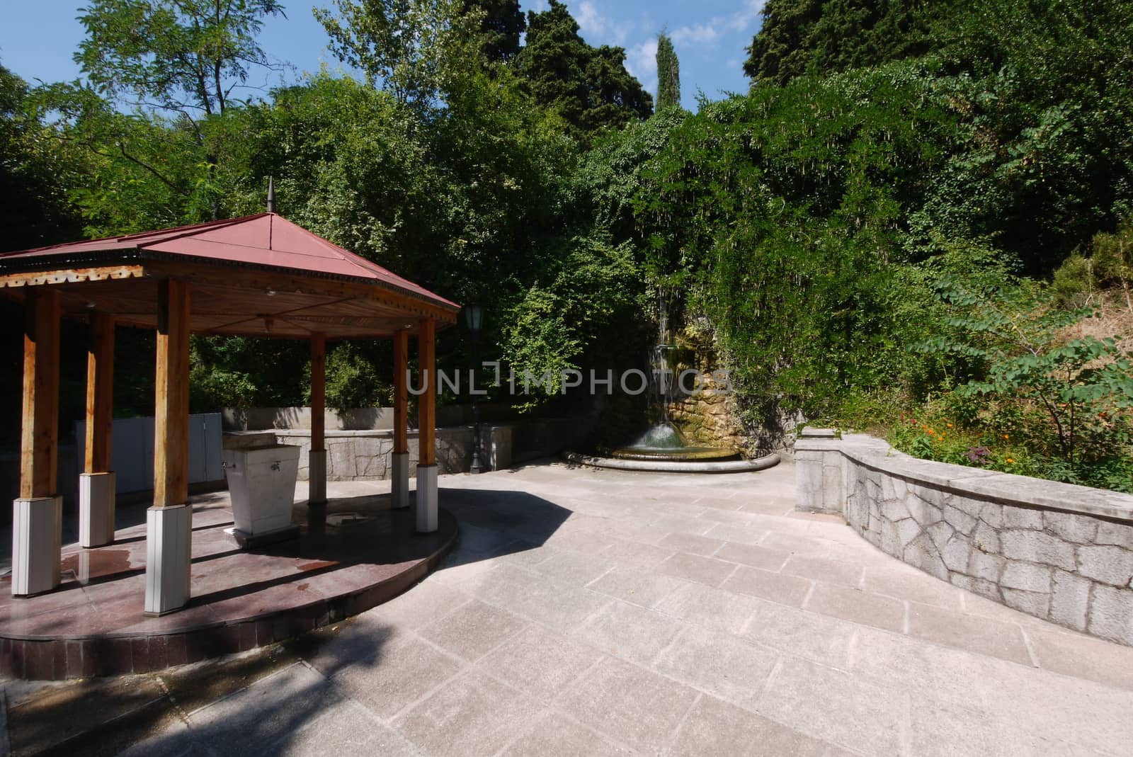 canopy on six pillars and a fountain in the park by Adamchuk