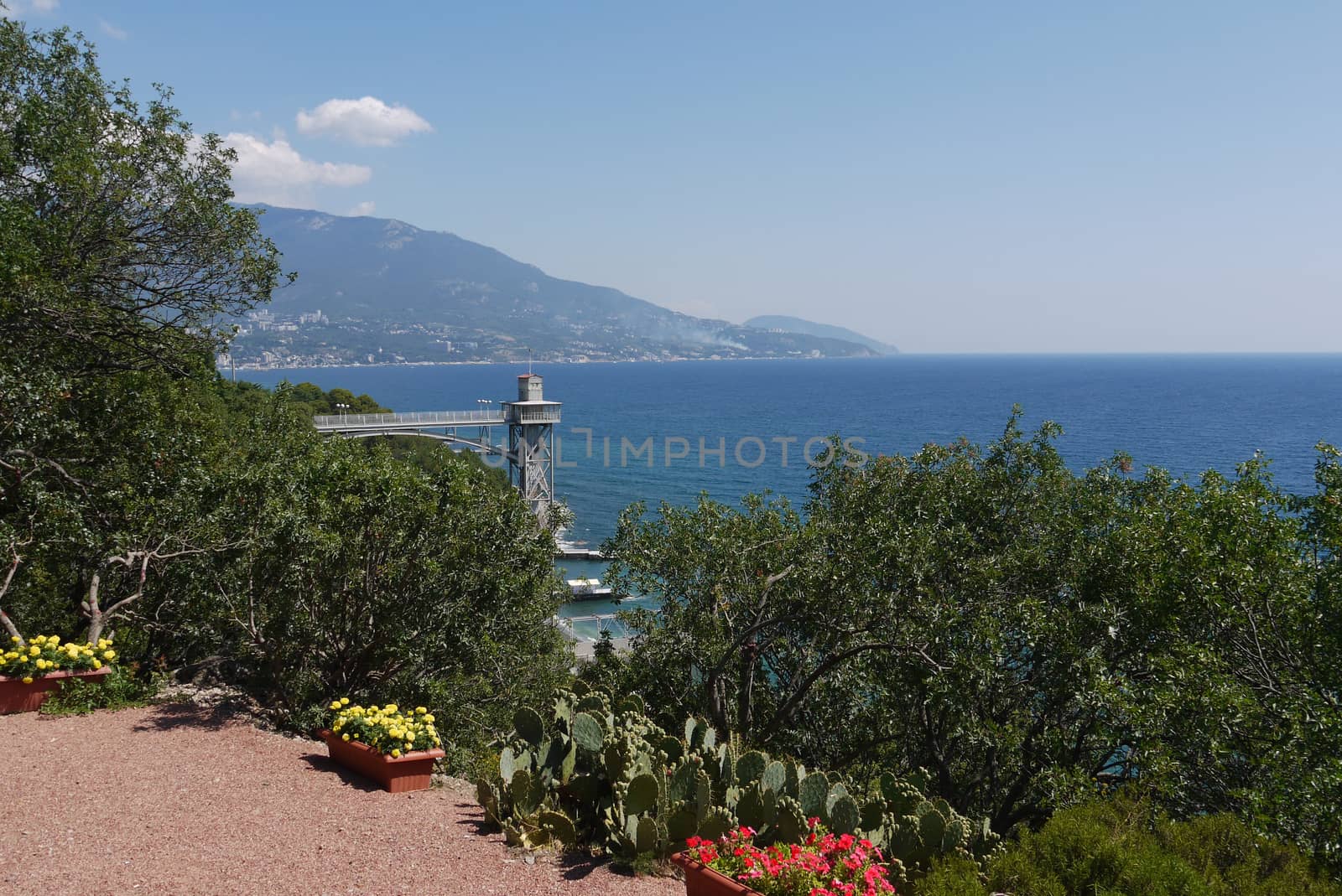 A beautiful mountain shore of the sea, from which you can see the horizon. It seems that the sea smoothly passes into the blue sky by Adamchuk