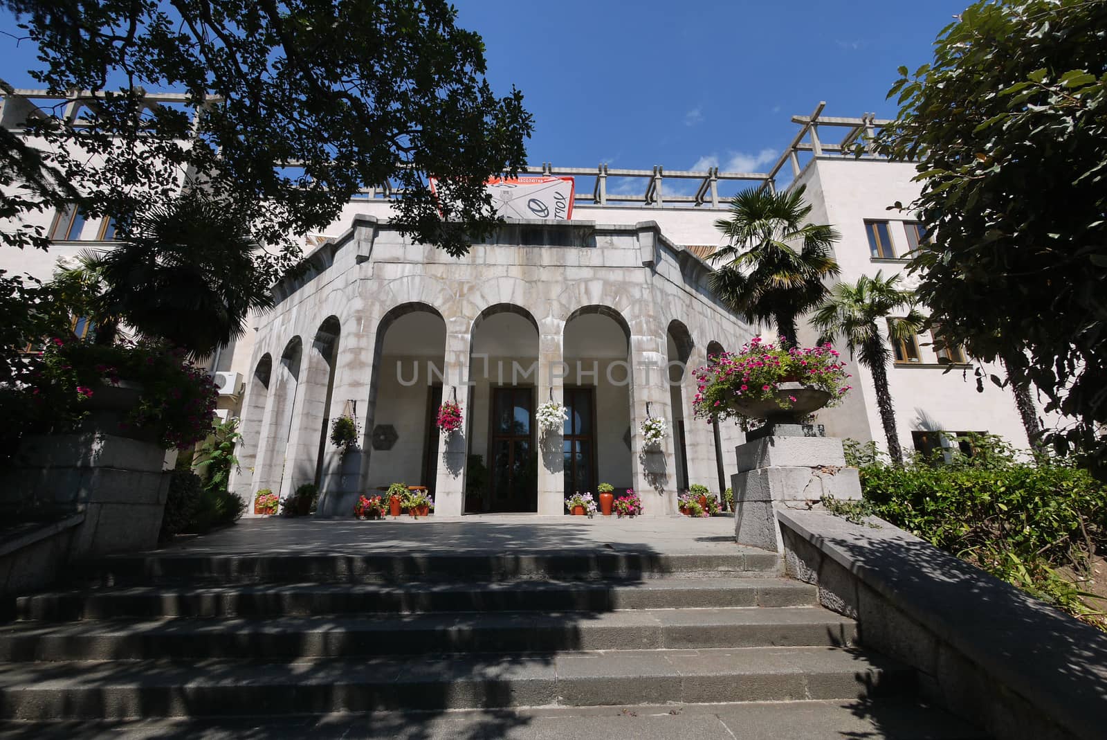 Steps leading to the building with beautiful wide square pillars at the entrance by Adamchuk