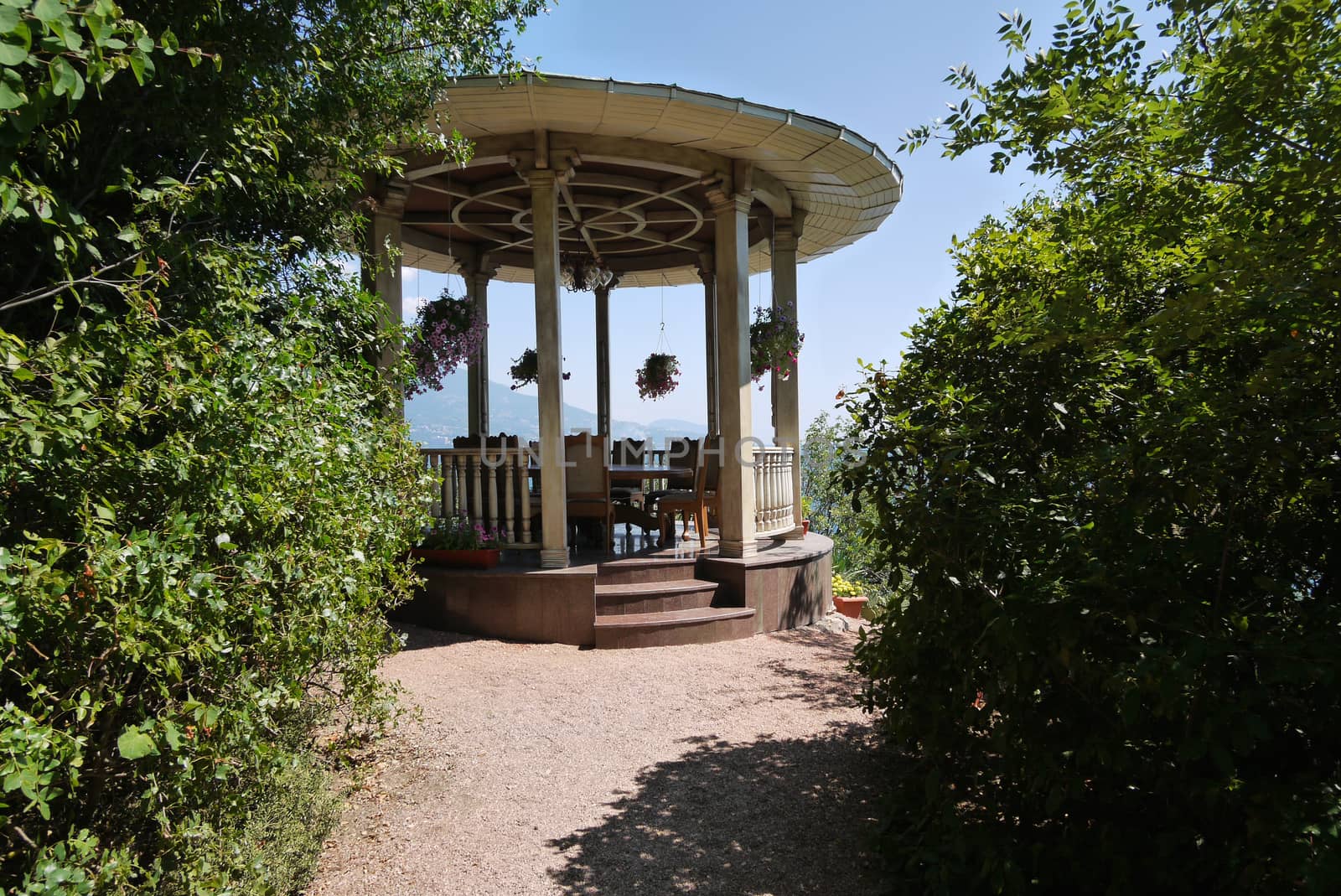 A beautiful small table with a cover in the park on the background of a beautiful mountain landscape by Adamchuk