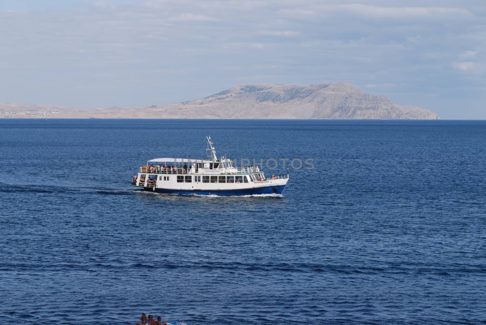 A boat that passes tourists to the other shore through the endless blue sea