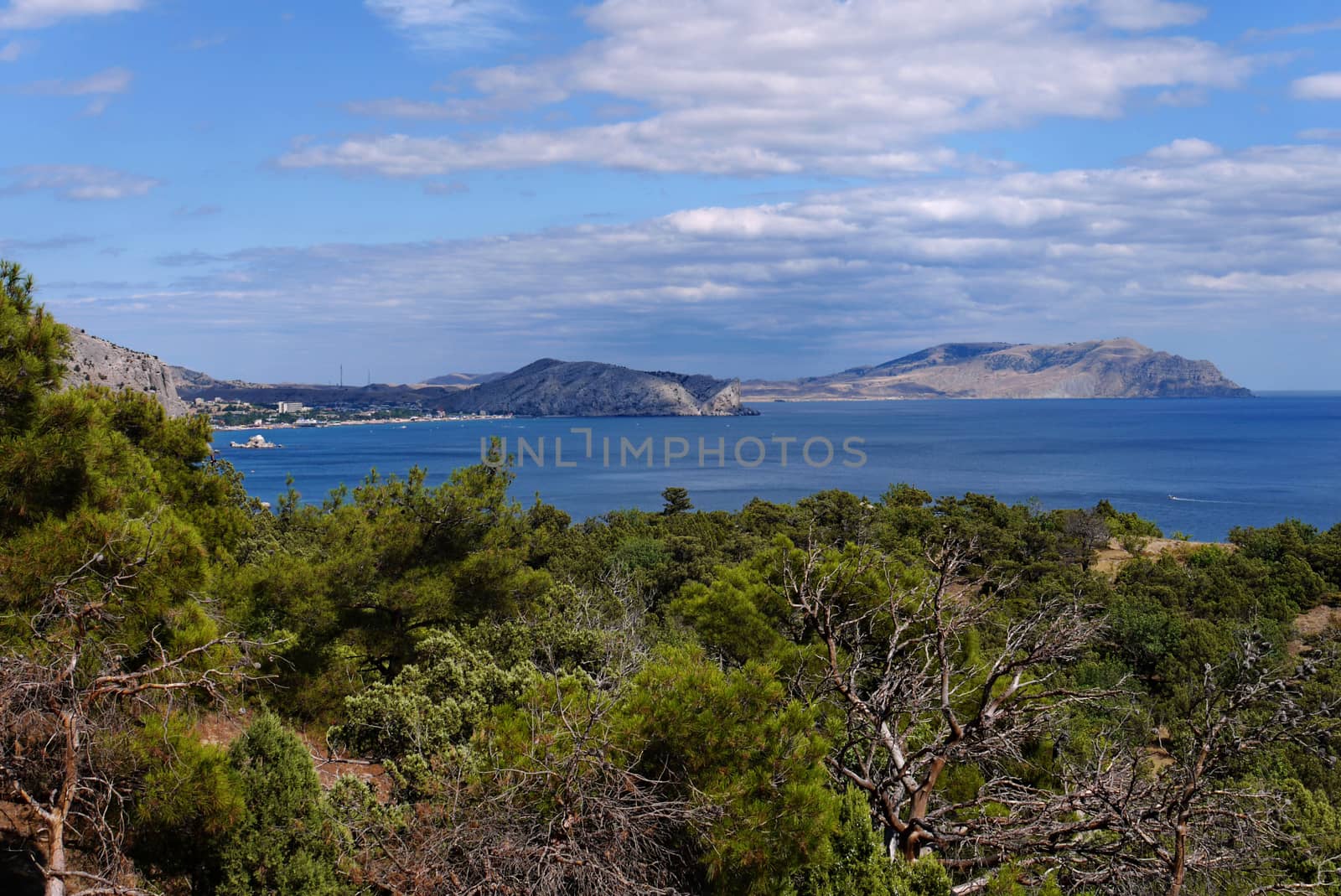 distant rocky mountains in the blue waters of the sea at the foot of which the town was located