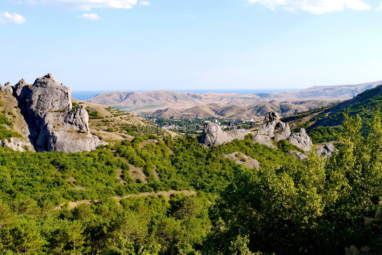 A small village surrounded by boundless mountains on the background of the Black Sea by Adamchuk