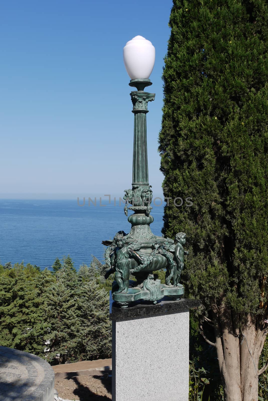 A chic lamp standing on a stand with figures of angels with wing by Adamchuk