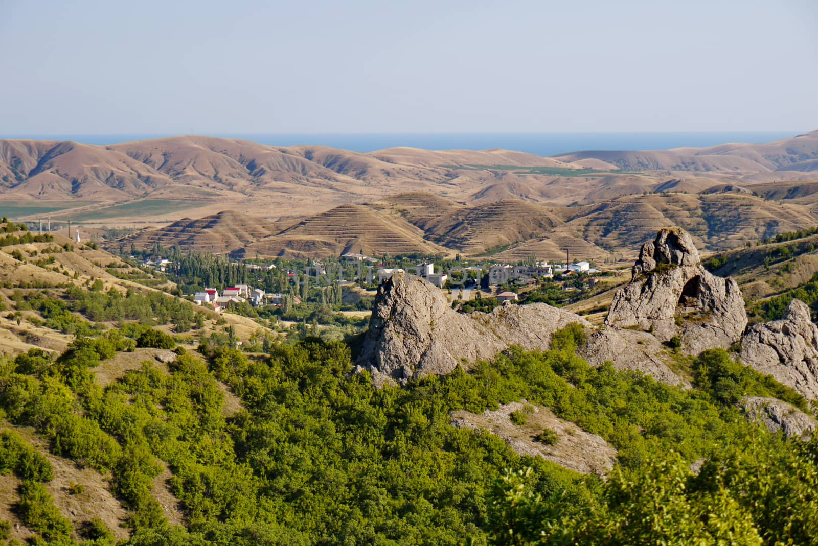 A small village surrounded by boundless mountains on the background of the Black Sea