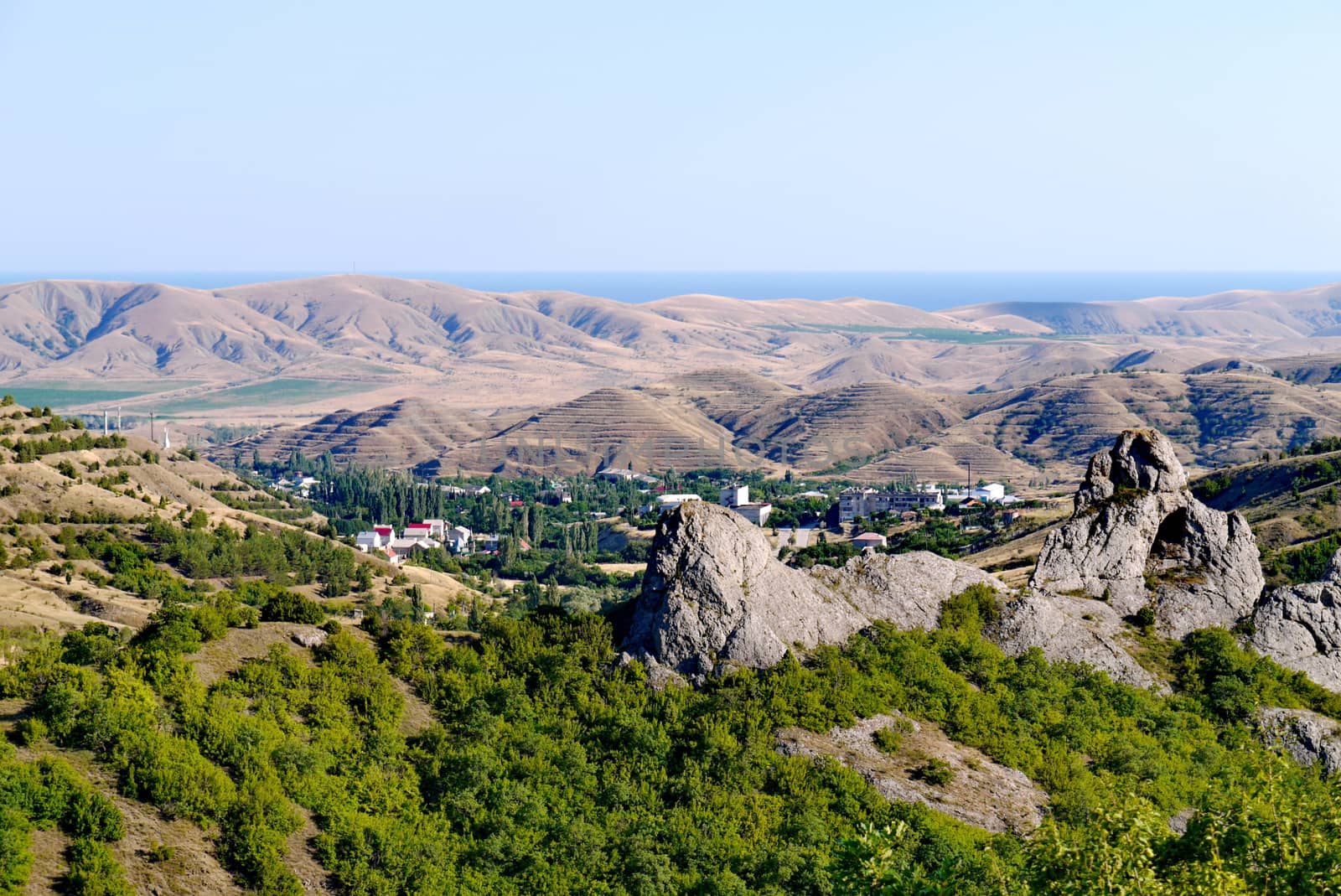 A small village surrounded by boundless mountains on the background of the Black Sea