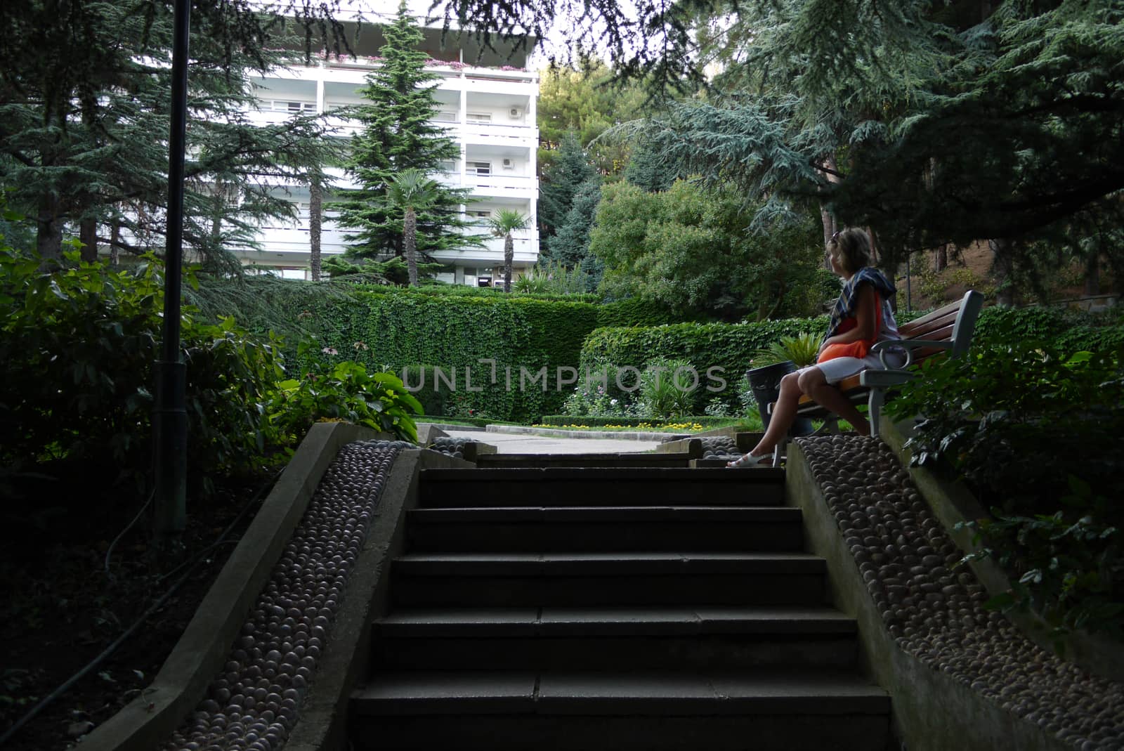 A woman sitting alone on a bench. Perhaps he is waiting for his chosen one by Adamchuk