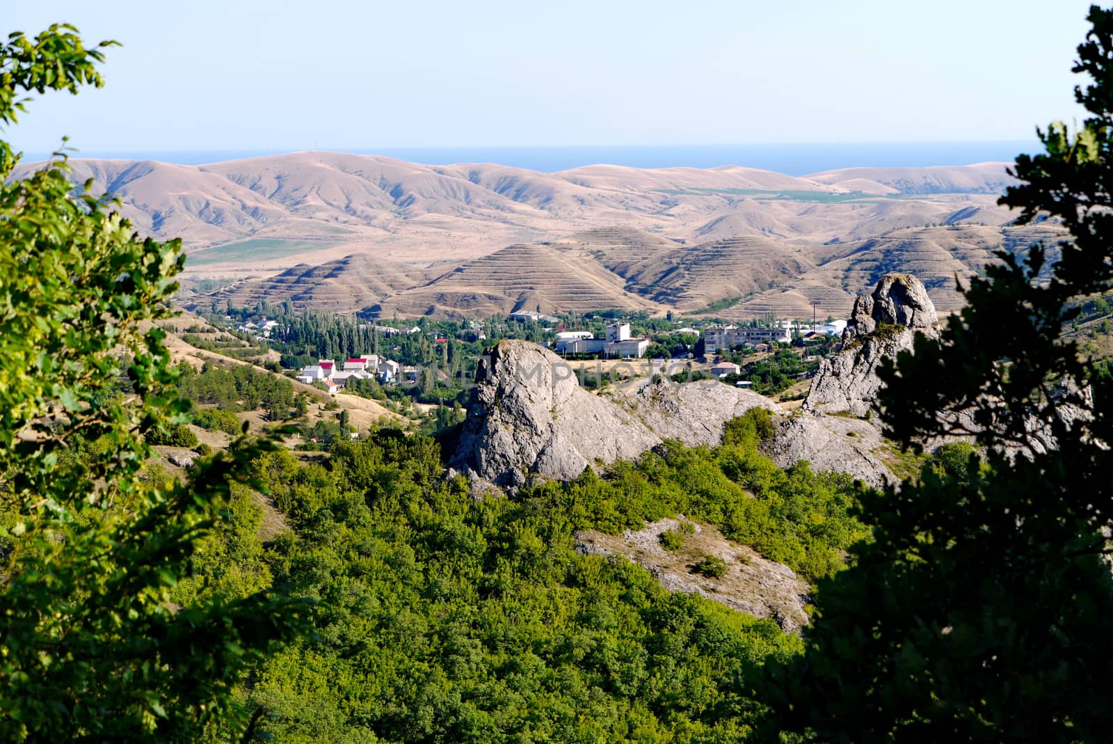 A small village surrounded by boundless mountains on the background of the Black Sea by Adamchuk