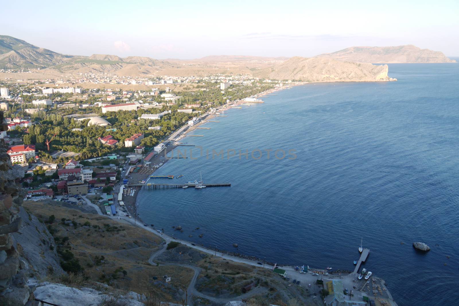 a quiet town on the shores of the Black Sea against the background of beautiful endless mountains by Adamchuk