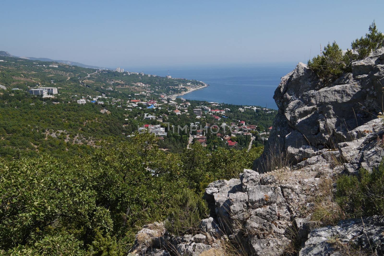 small grass-covered rocks on the background of a beautiful coastal town