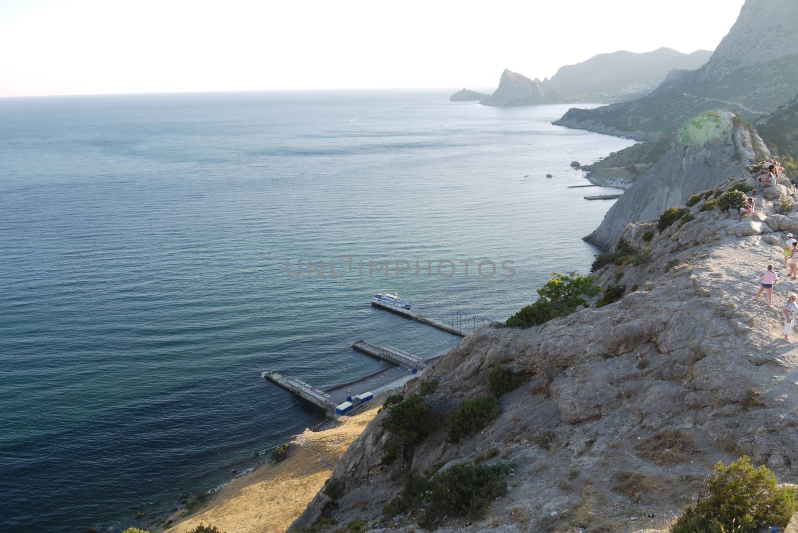 High, beautiful mountains on the shore of a deep black sea