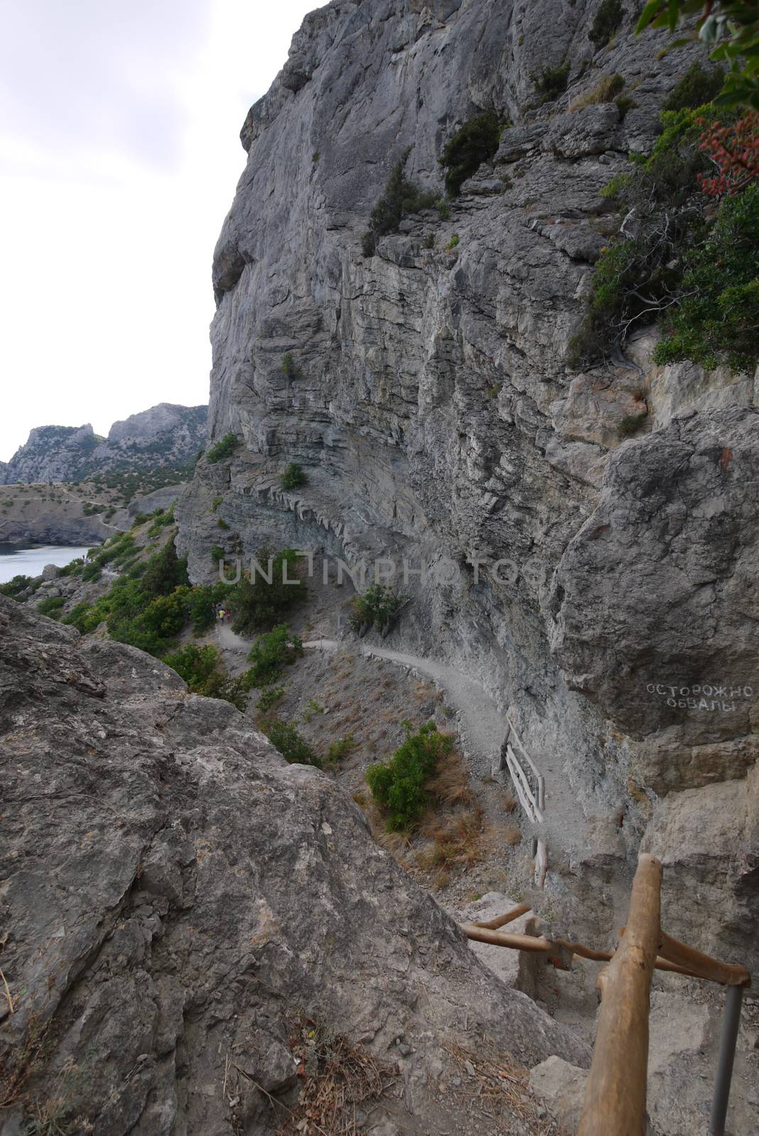 narrow rocky path under high steep mountains