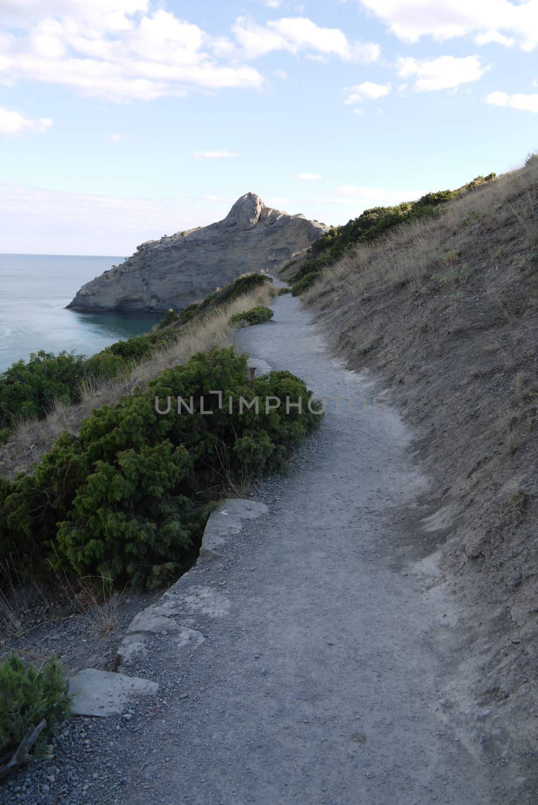 a small path on the background of rocks and boundless black sea by Adamchuk