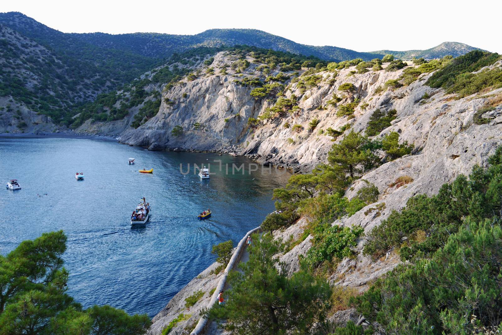 deep bay in the deep sea is surrounded by endless grass-covered rocks. Walking in the nature