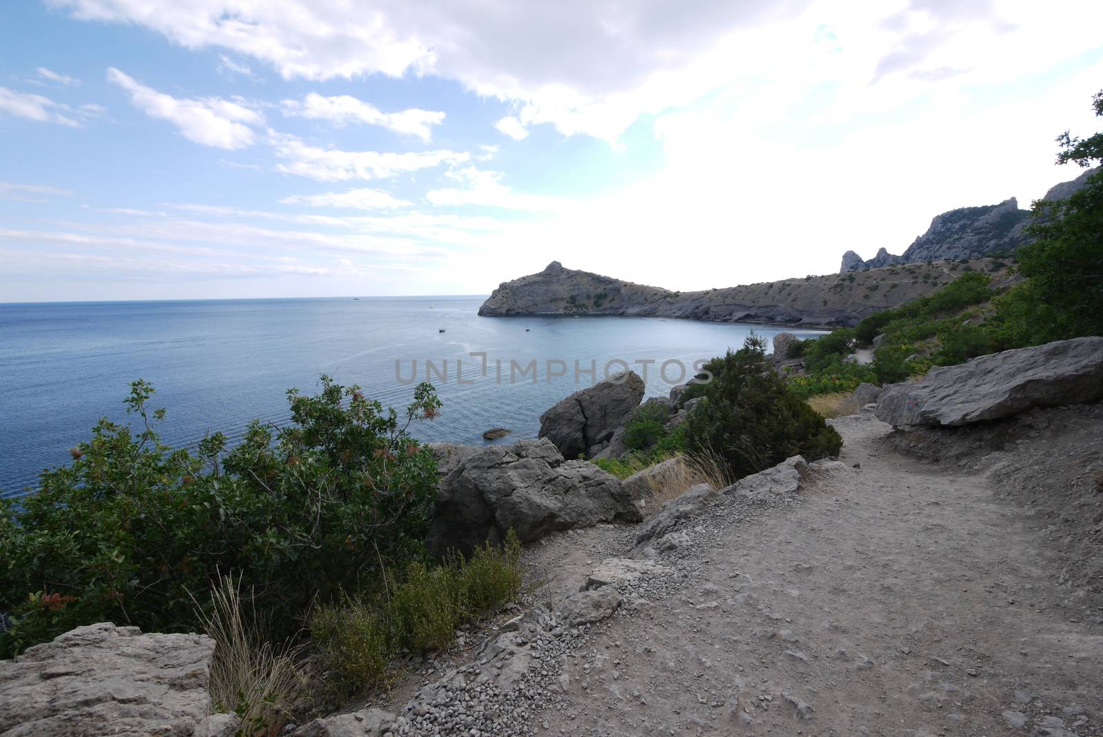 narrow rocky track on the background of a large deep bay by Adamchuk