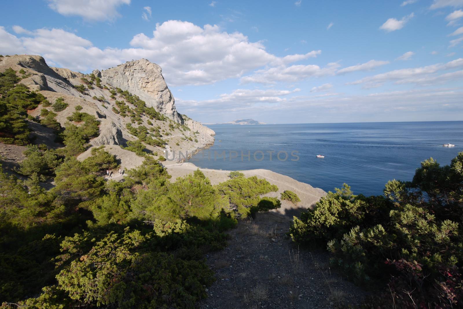 beautiful Crimean slopes on the shore of the Chanoe sea.Tipping on the beach by Adamchuk