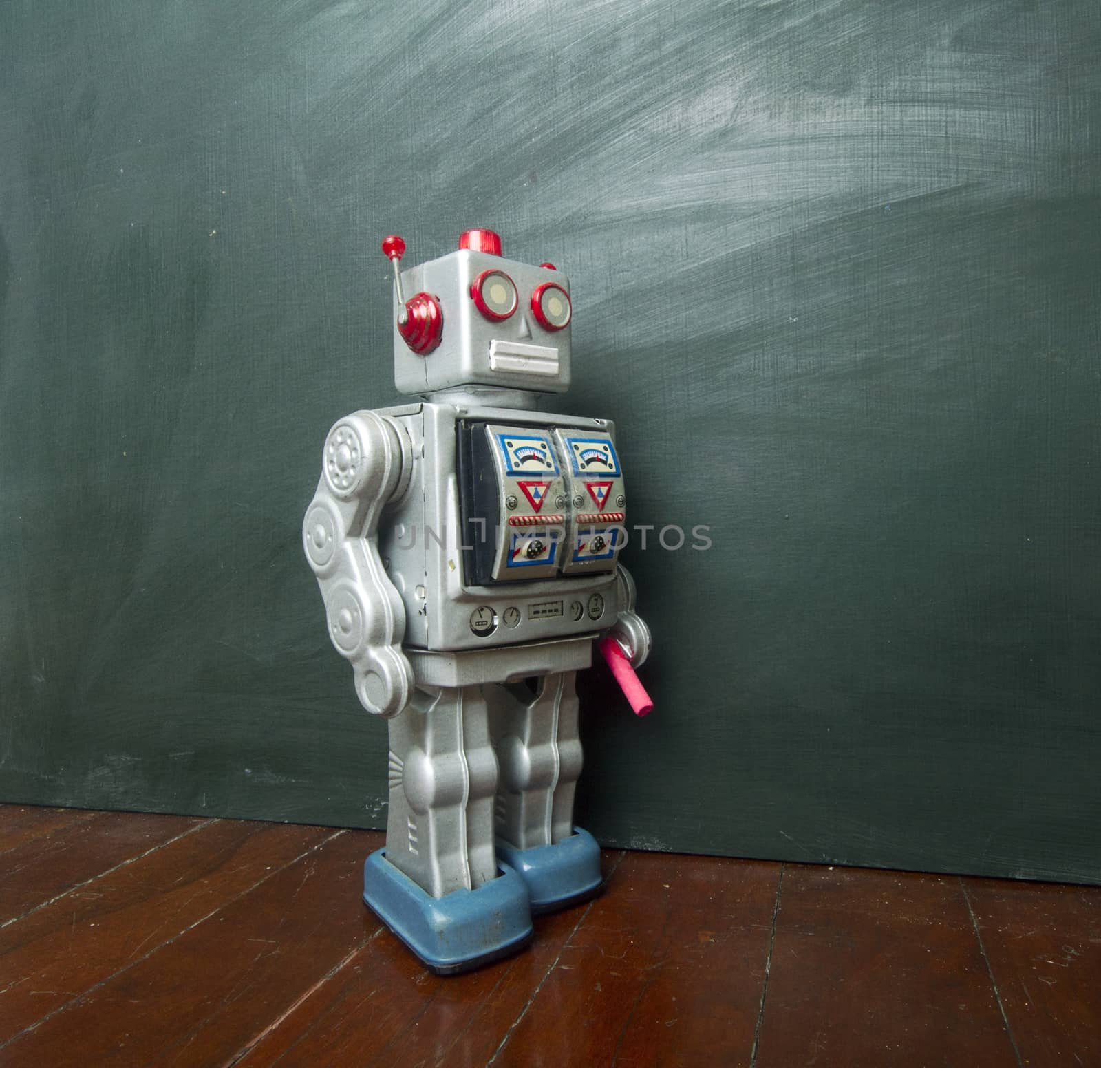 vintage robot writes on black board 