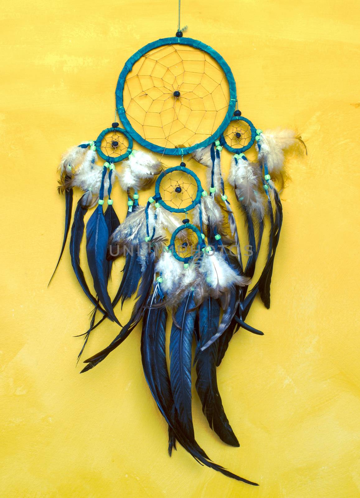 Dream catcher on old yellow  wall