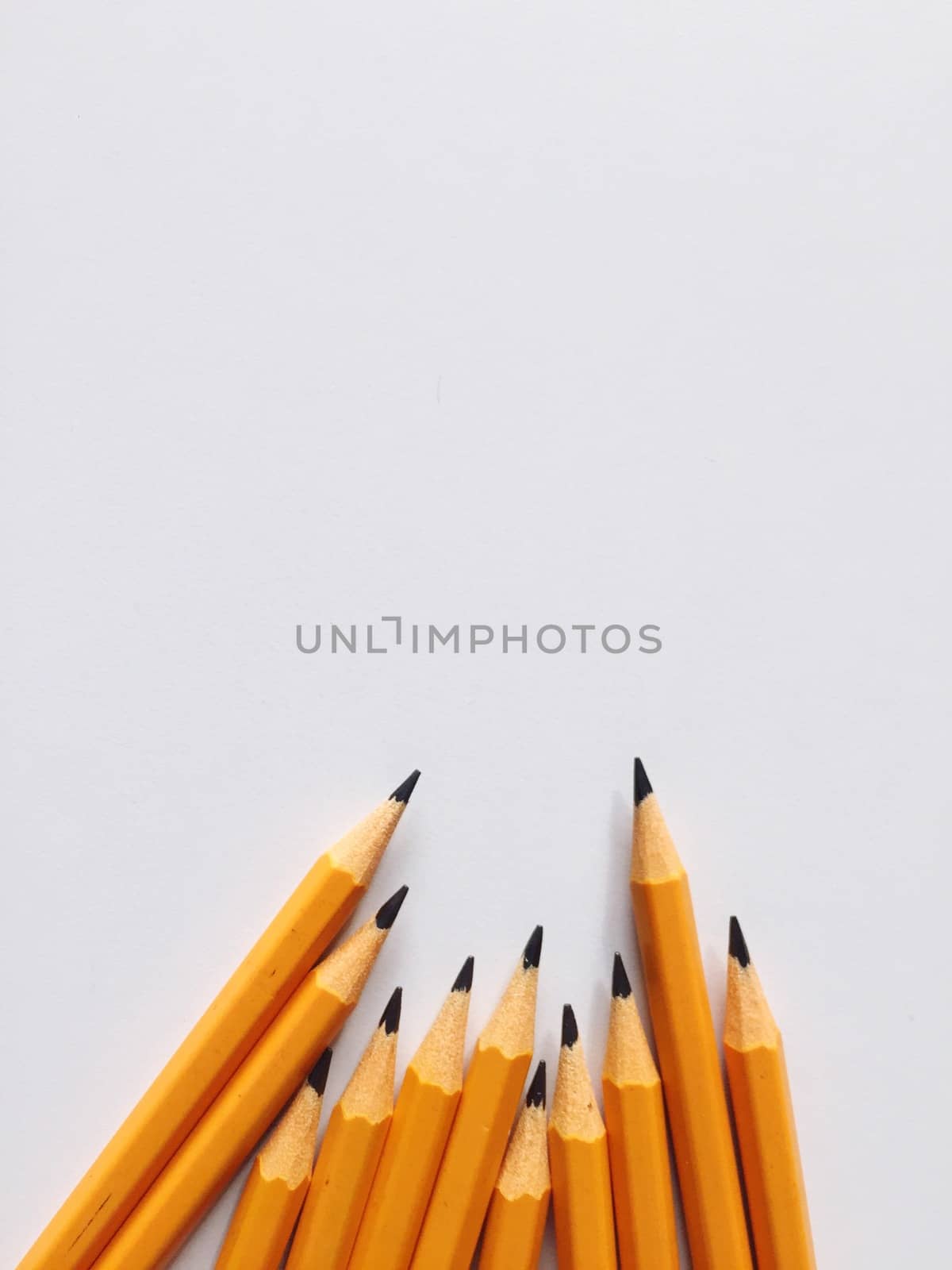 Group of yellow pencils on a white plane