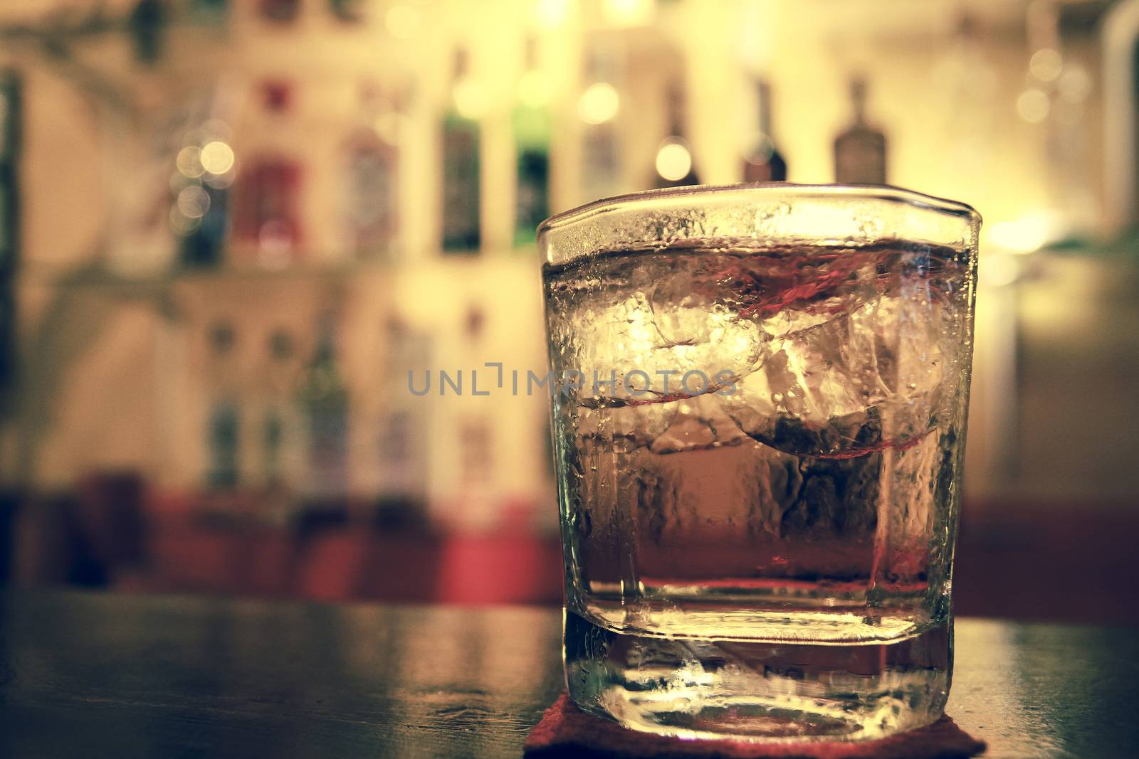 A glass of whiskey on the bar macro image 