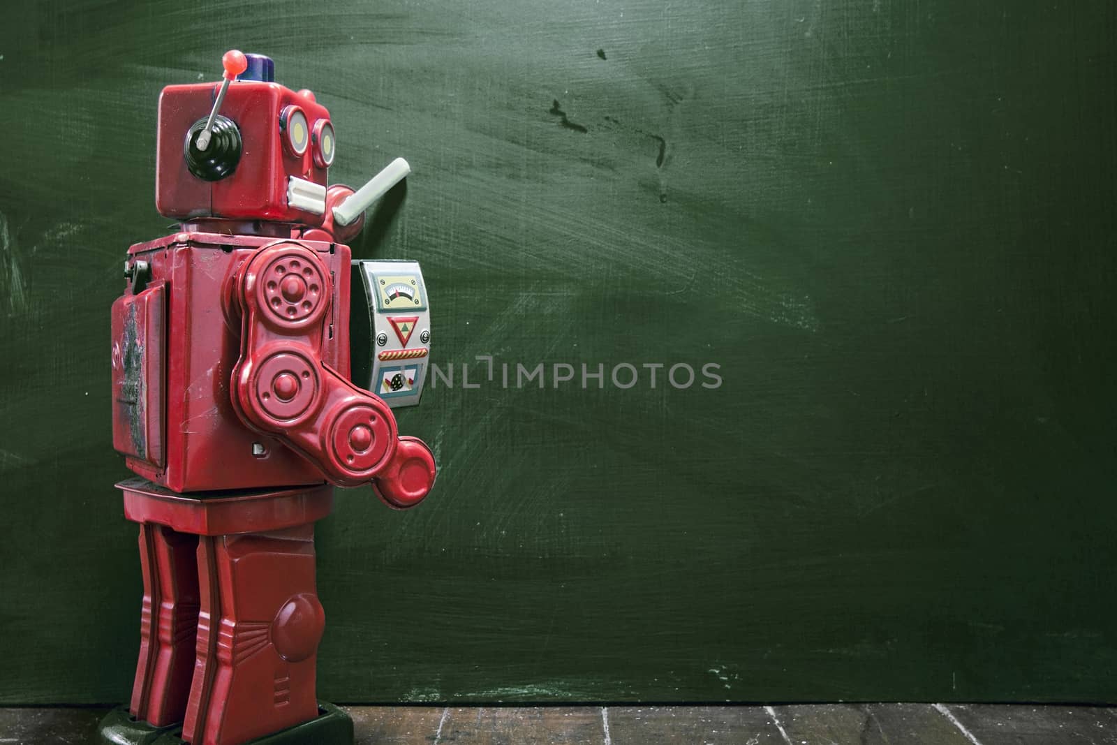 vintage robot writes on black board 