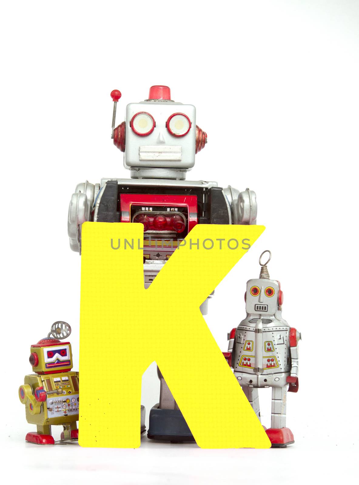 capital letter  K held by vintage robot toys 