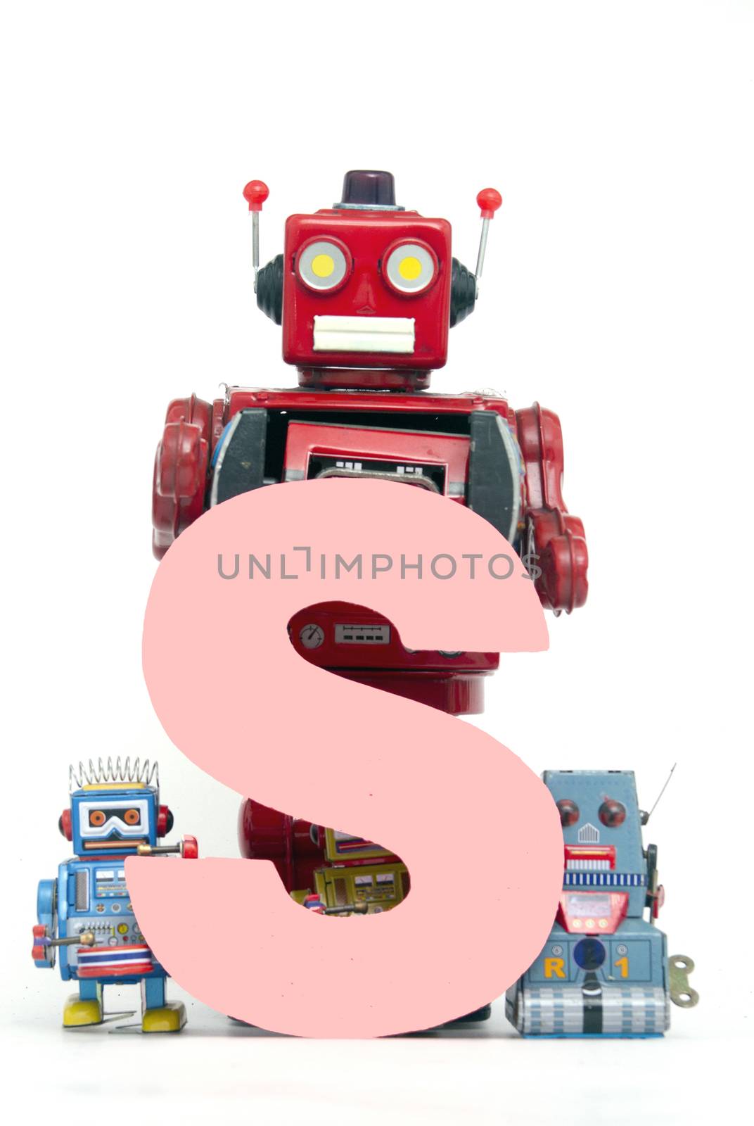 capital letter S held by vintage robot toys 