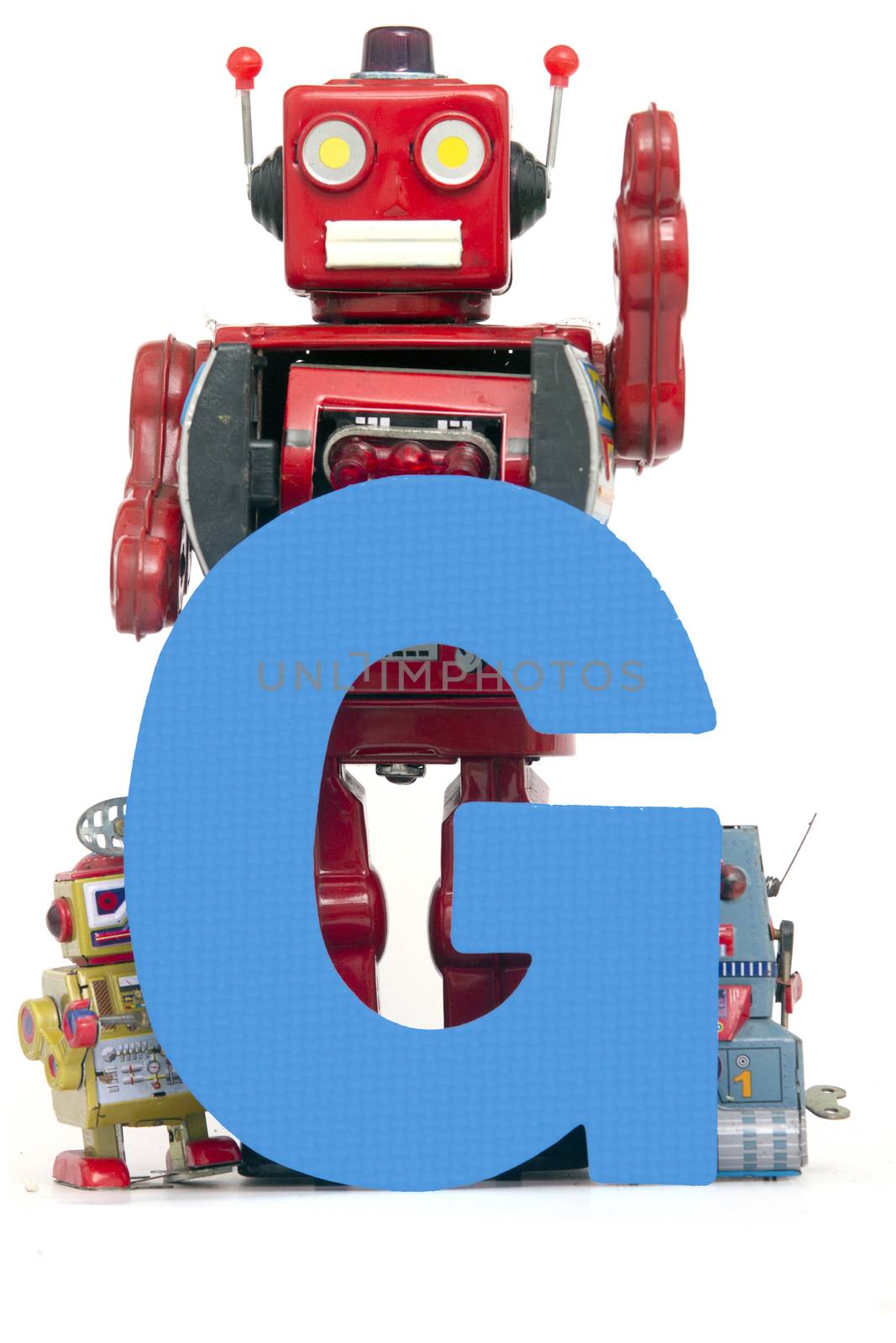 capital letter G held by vintage robot toys 