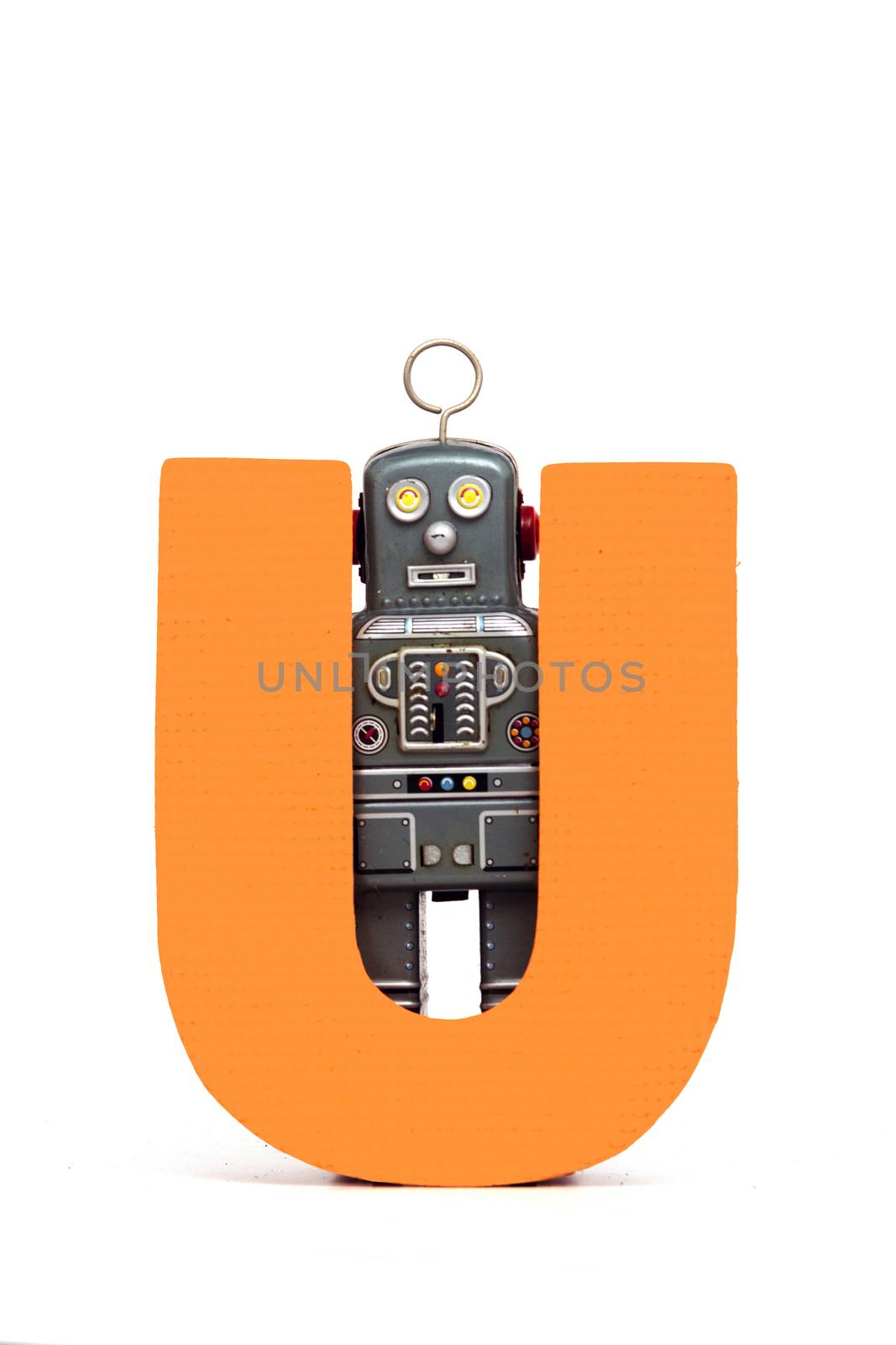 capital letter U held by vintage robot toys 