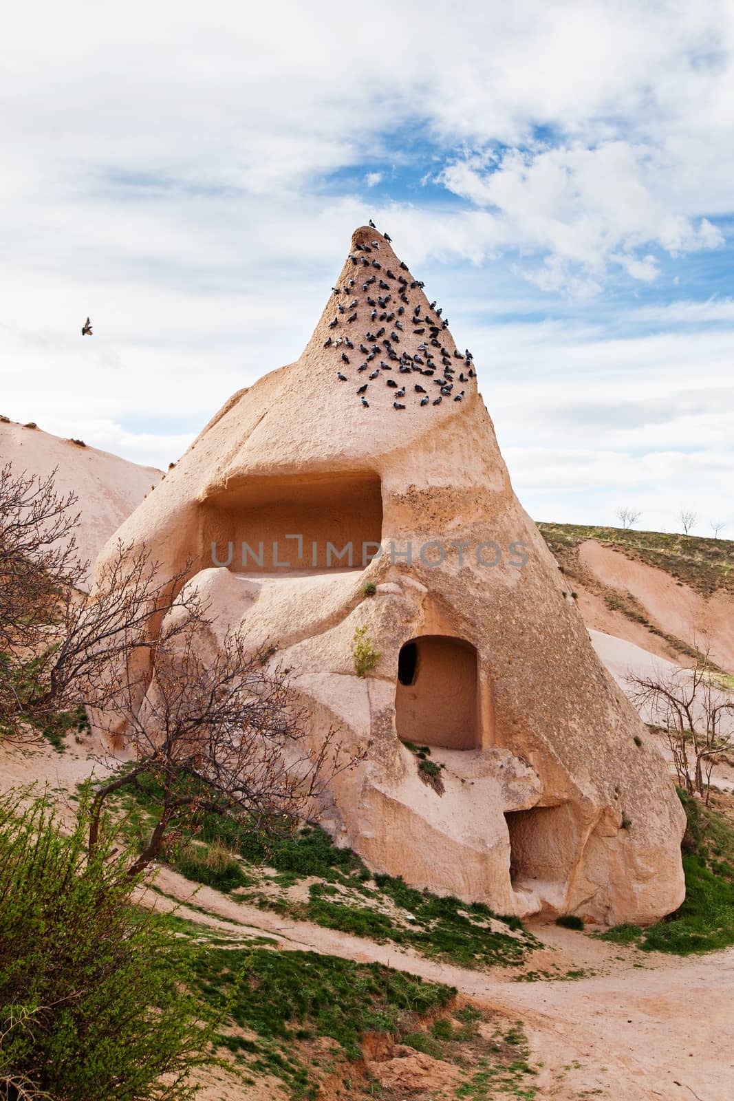 Stone cliffs and cave houses in Uchisar near Goreme, Turkey