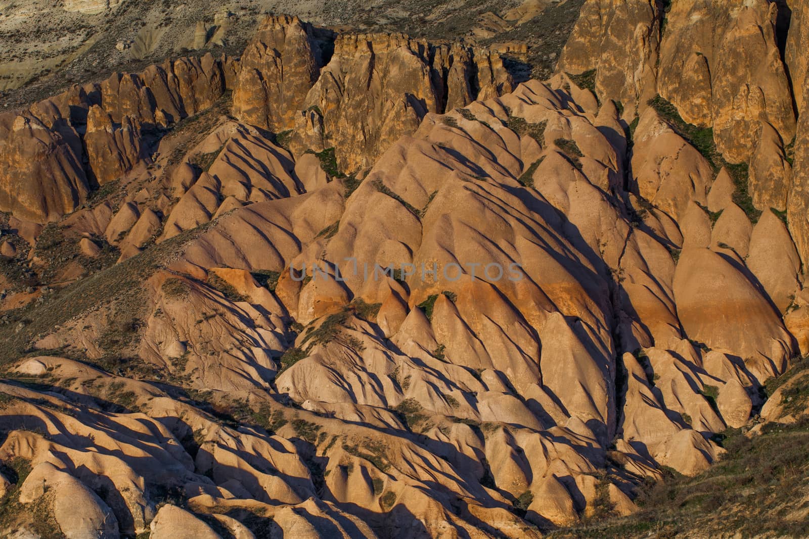 Cylindrical stone cliffs and cave houses near Goreme, Turkey