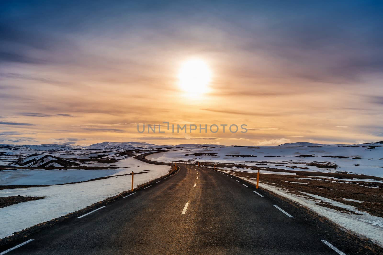 A long straight road at sunset in winter. 