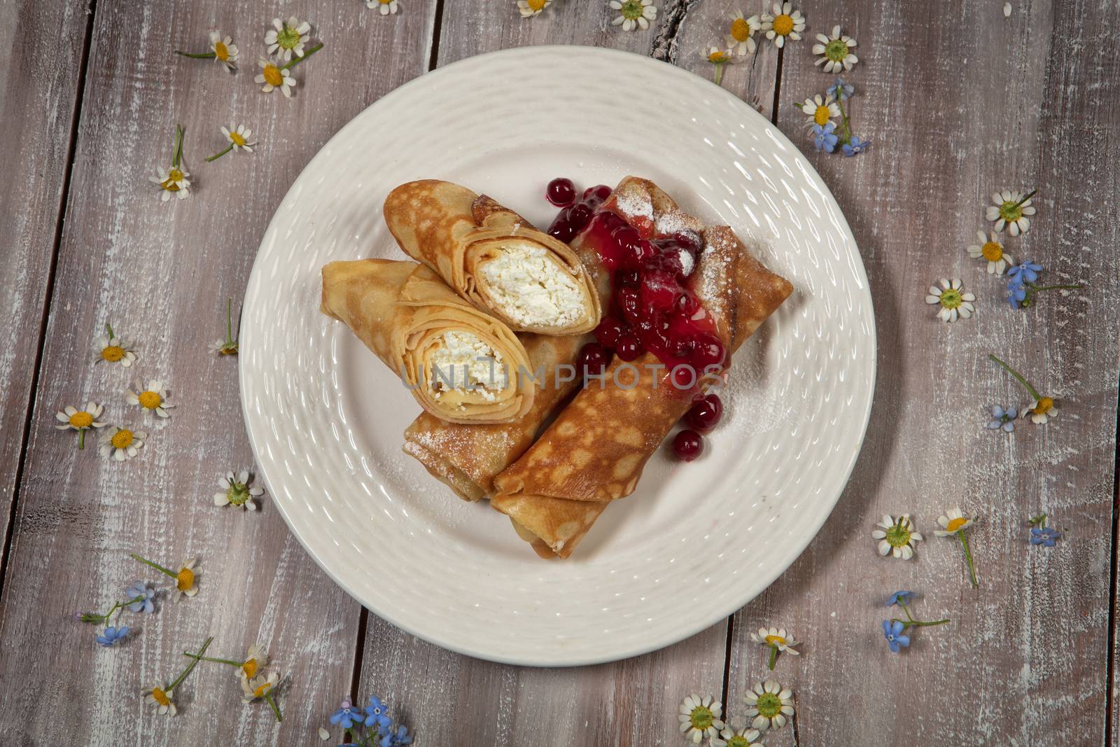 Pancakes with jam on an old wooden desk