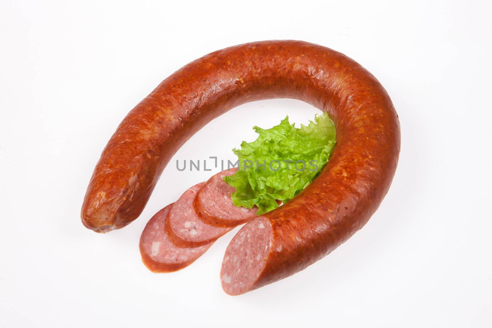 Sauage with greenery on isolated studio background