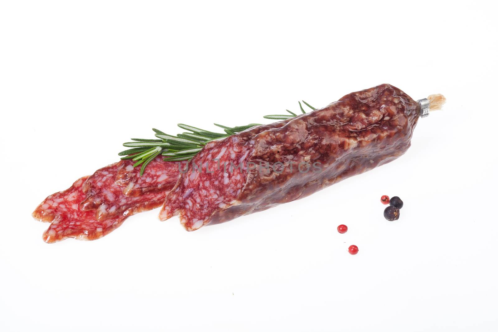 Isolated sausage with greenery on a white studio background