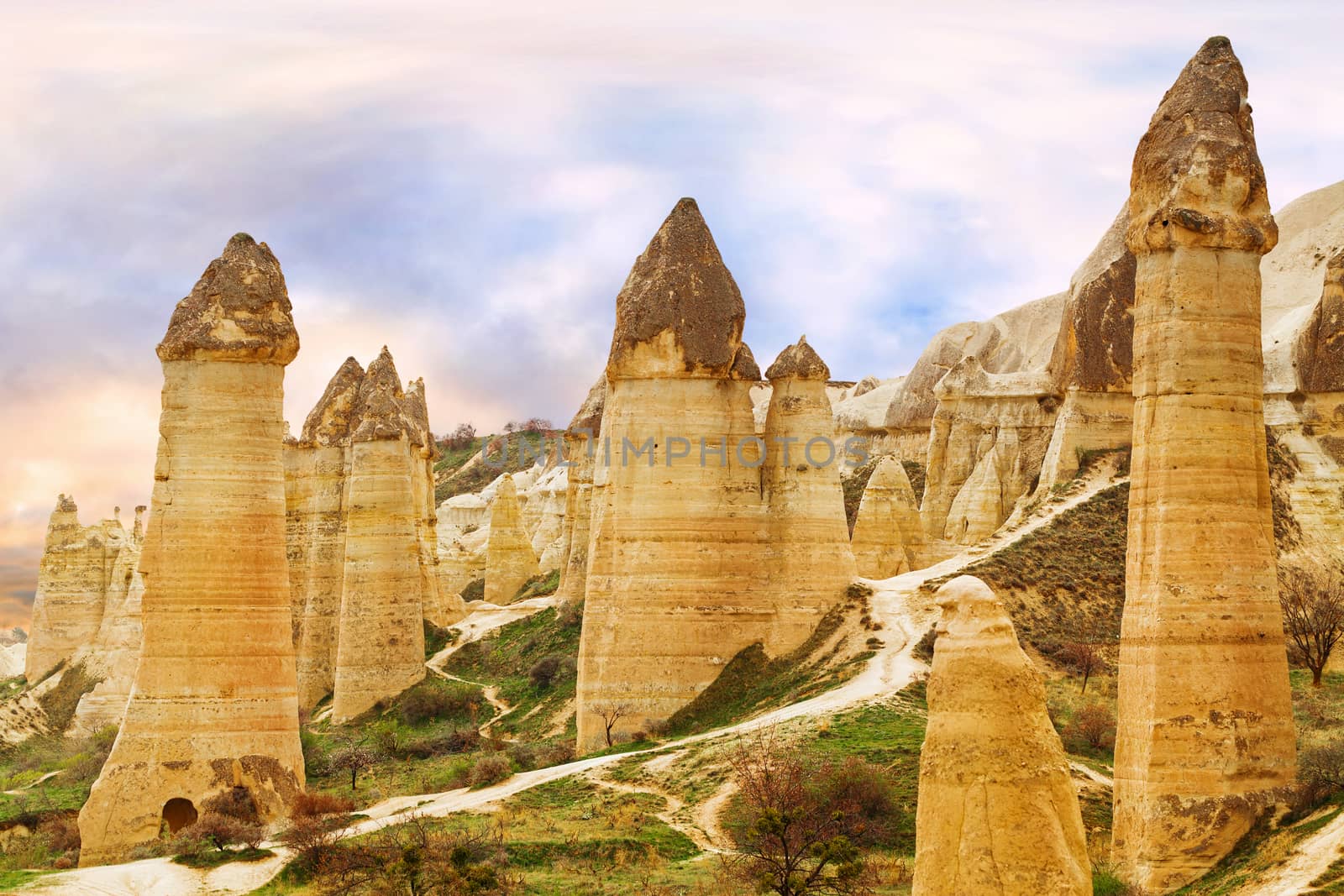 Cylindrical stone cliffs and cave houses in Love valley near Goreme, Turkey