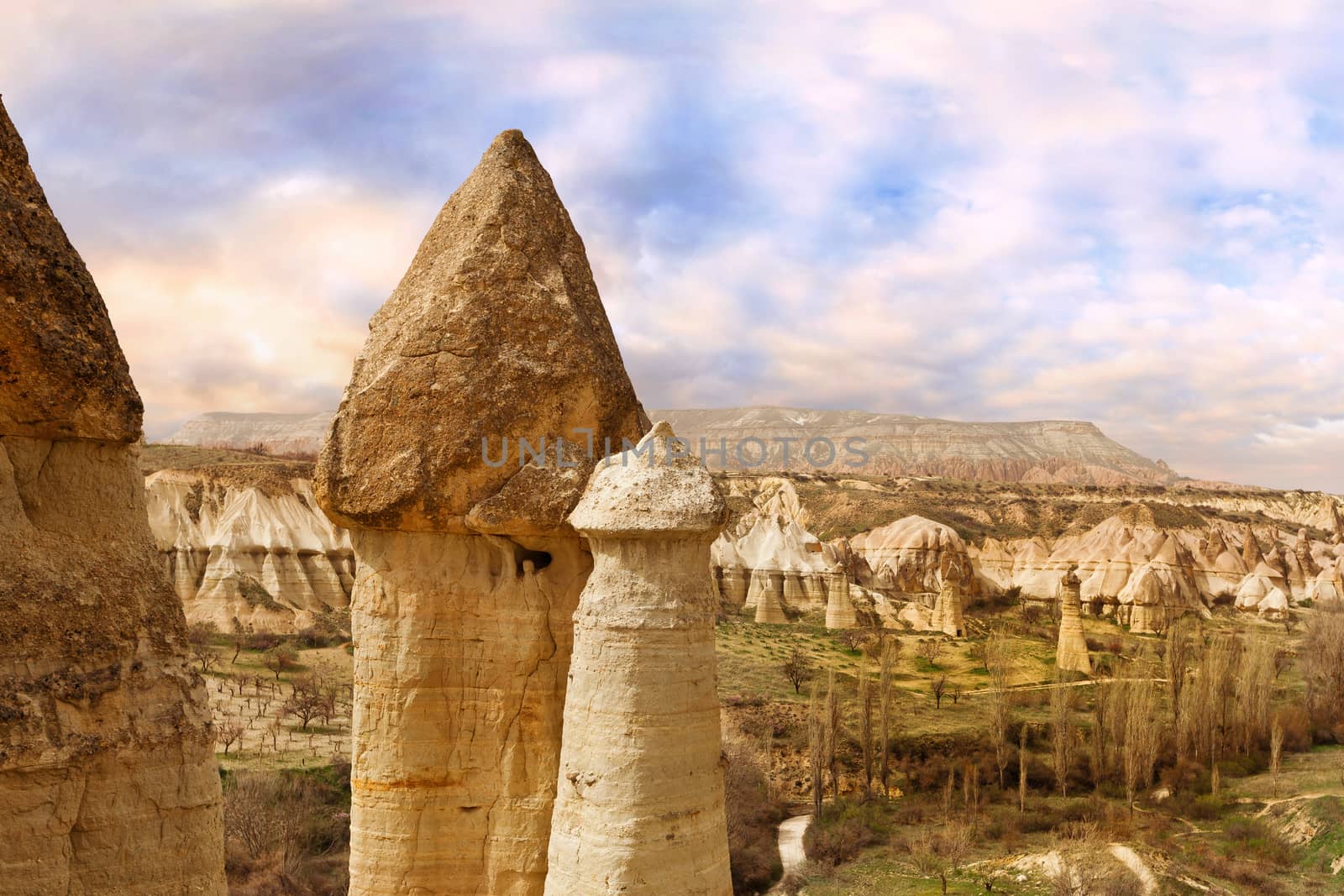 Cylindrical stone cliffs and cave houses in Love valley near Goreme, Turkey