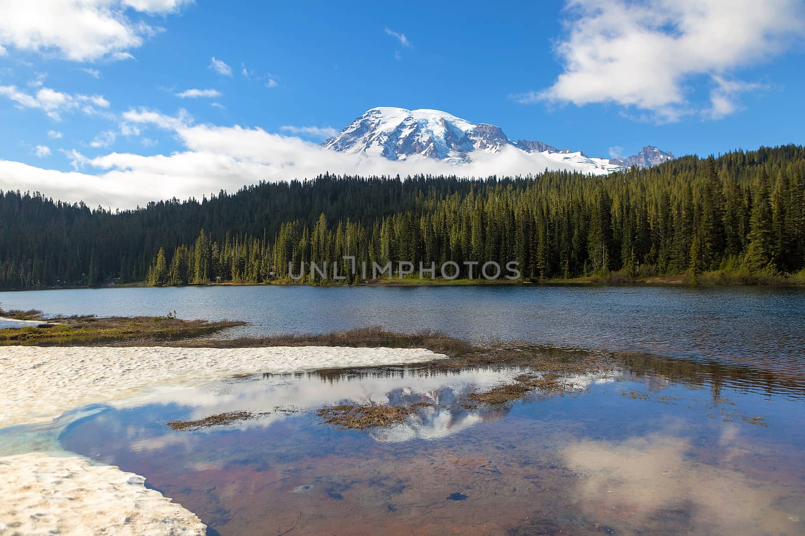 Reflection Lakes in Mount Rainier National Park in Washington State with snow clouds and blue sky