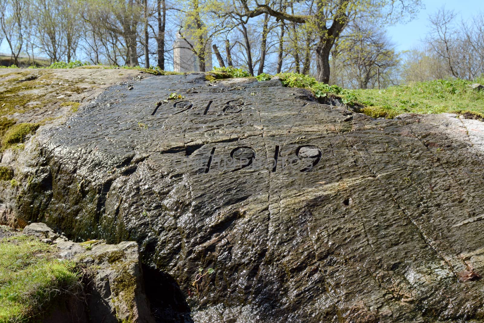 War memorial carved into rock under flowing water on Suomenlinna sea fortress in Finland