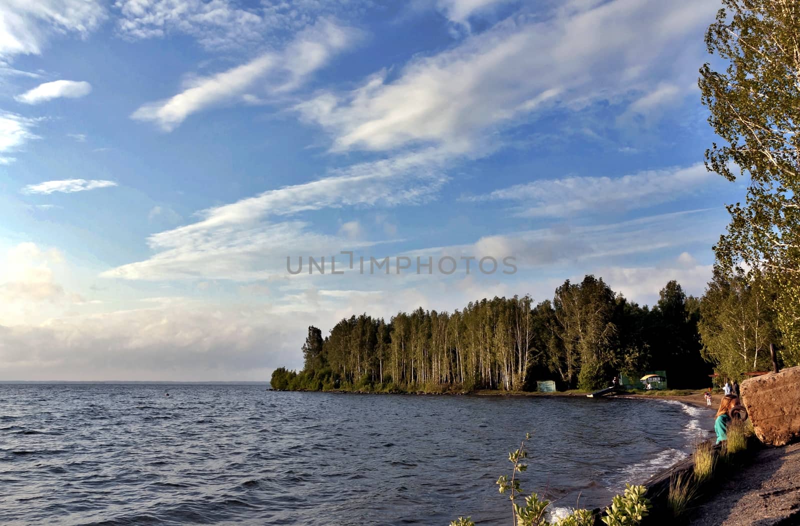 view of the blue sky over the lake with beautiful feathery and cumulonimbus clouds on a Sunny day, the southern Urals, lake Uvildy