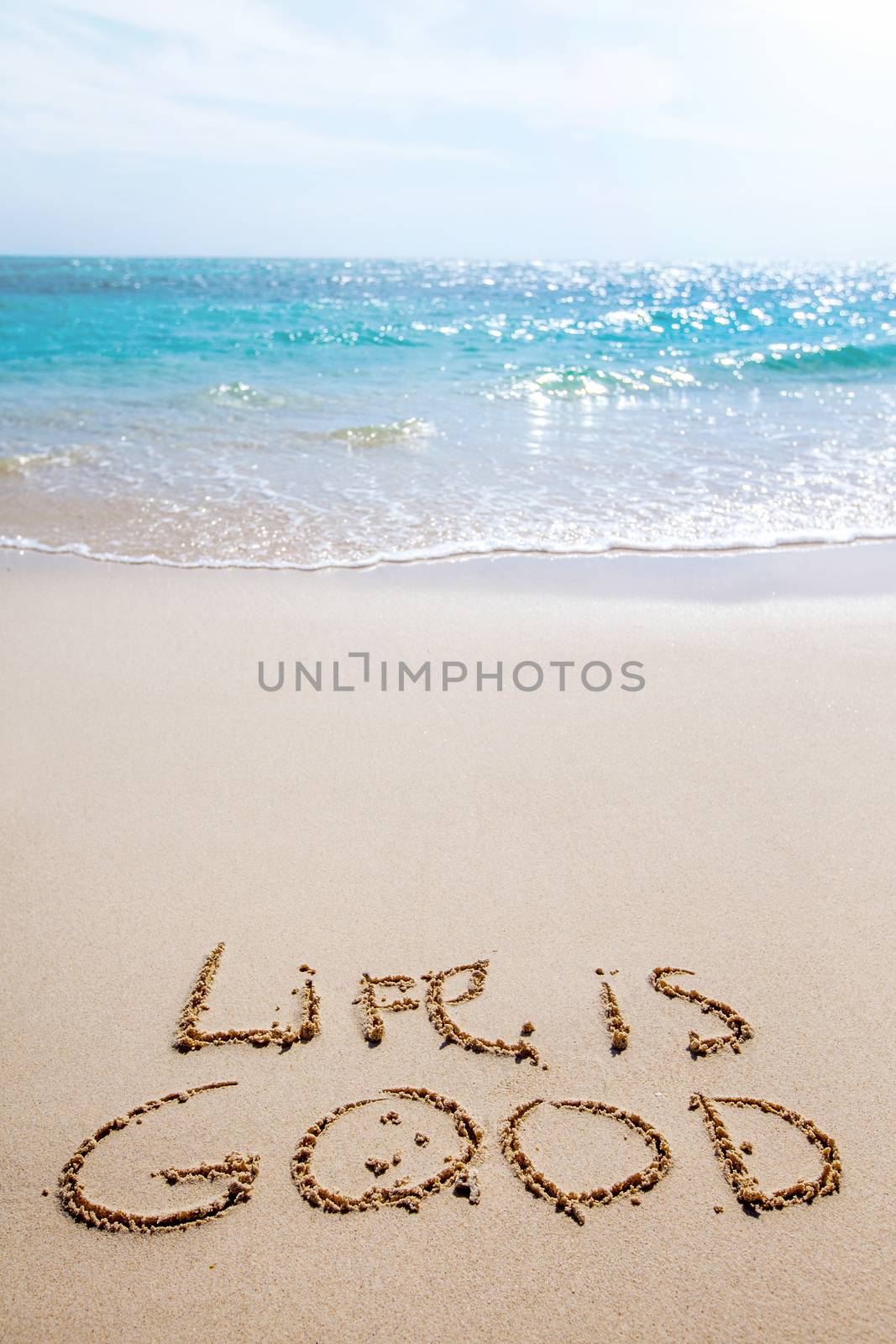 Positive thinking concept, life is good inscription on sand of tropical beach