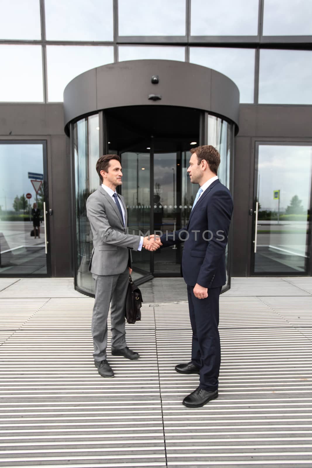 Business people shaking hands outdoor office building