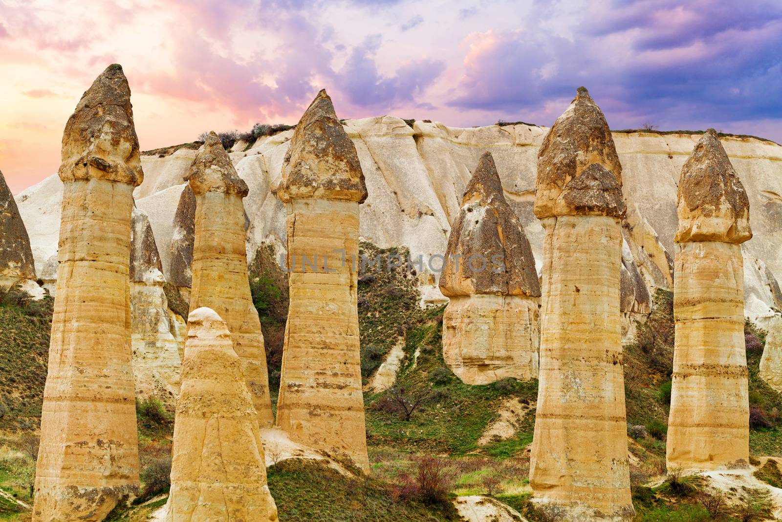 Cylindrical stone cliffs and cave houses in Love valley near Goreme, Turkey