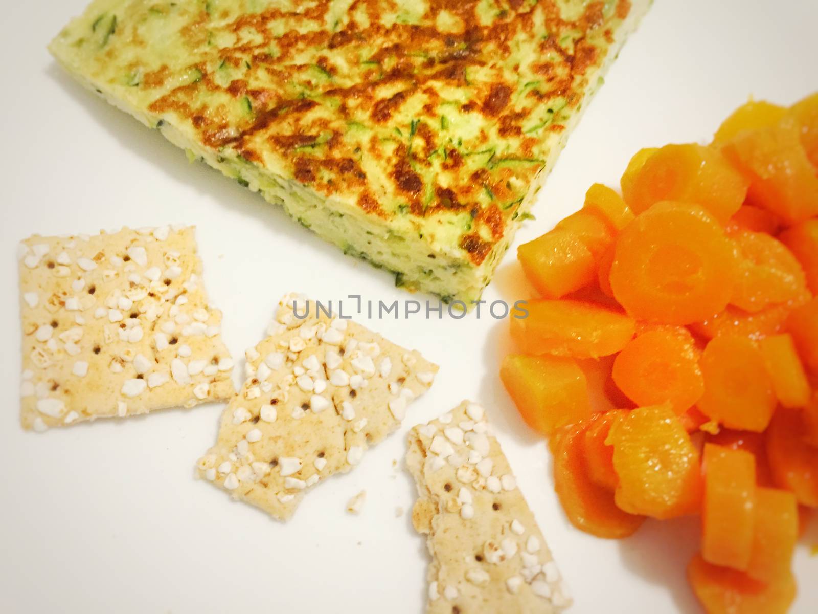 Healthy eating serving omelette with vegetables, carrots and crackers