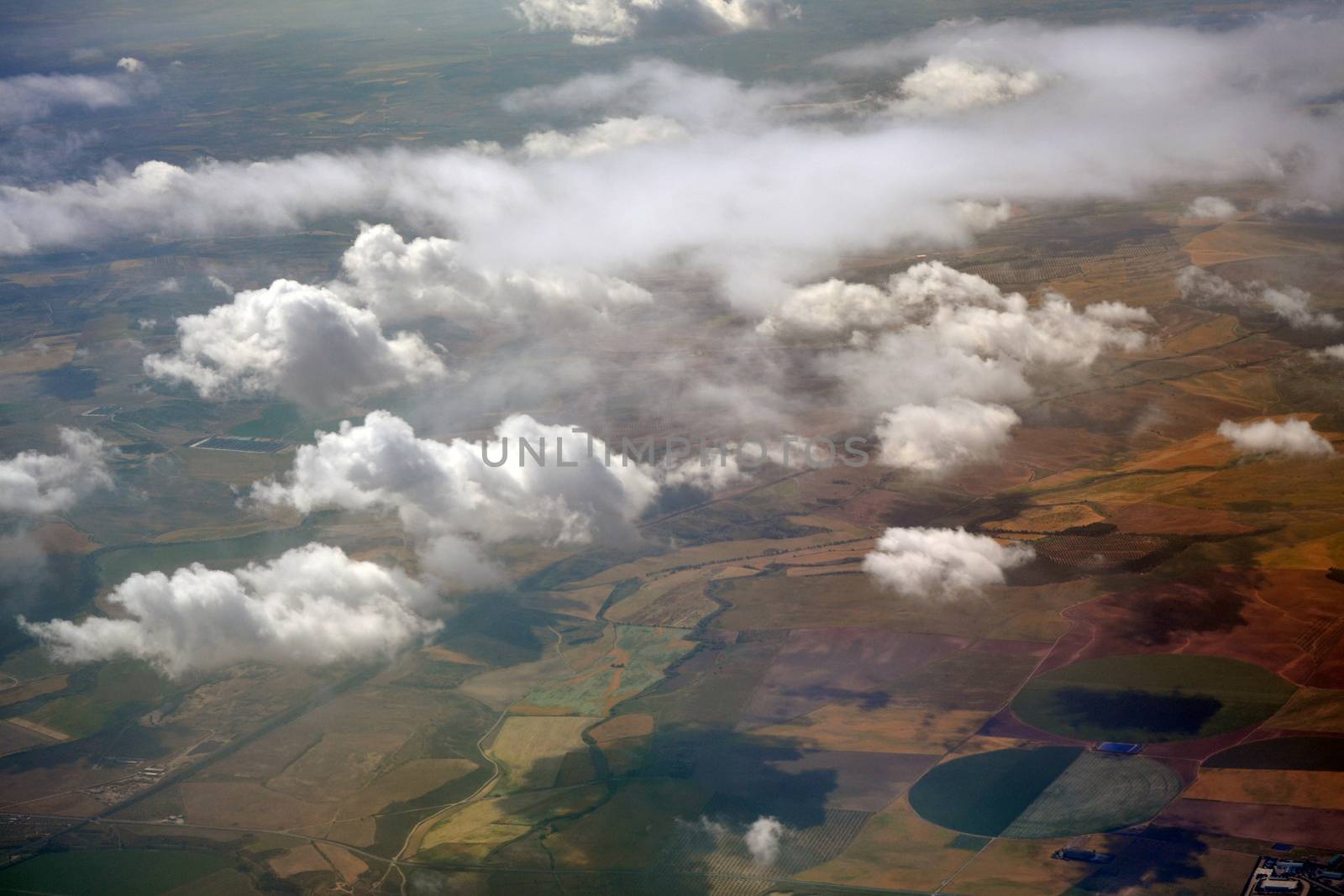 Patchwork farmland and clouds formations seen from the plane by hibrida13