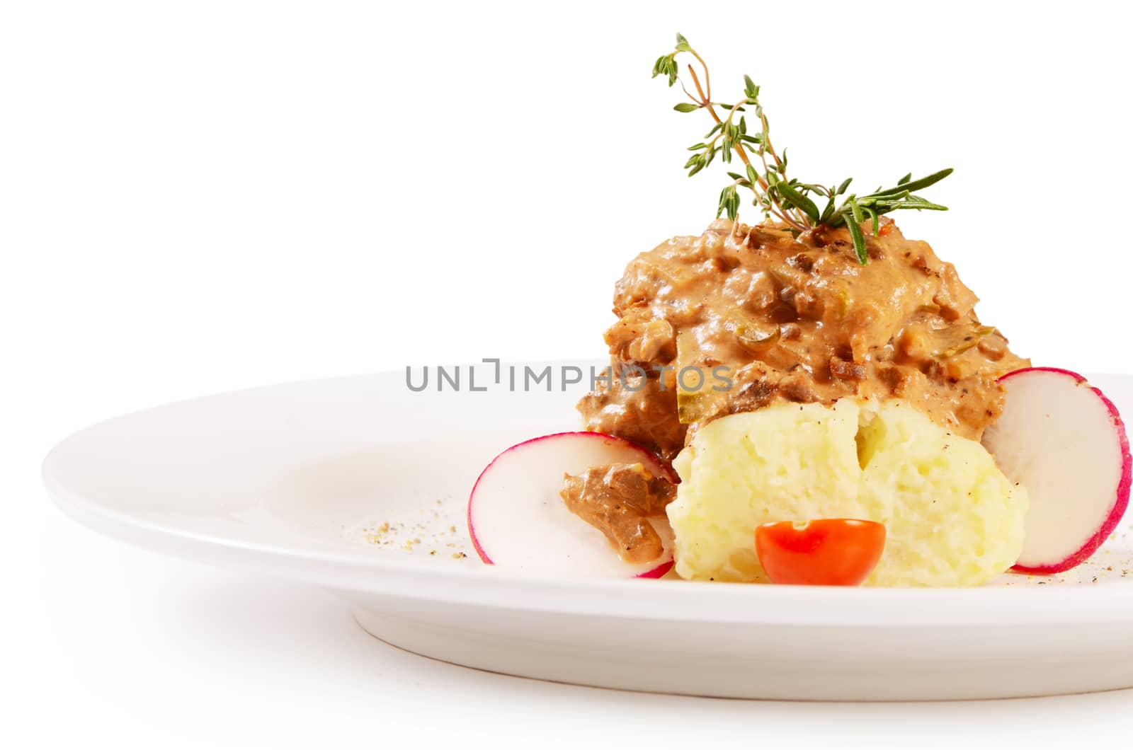 Potatoes with gravy, vegetables and meat isolated
