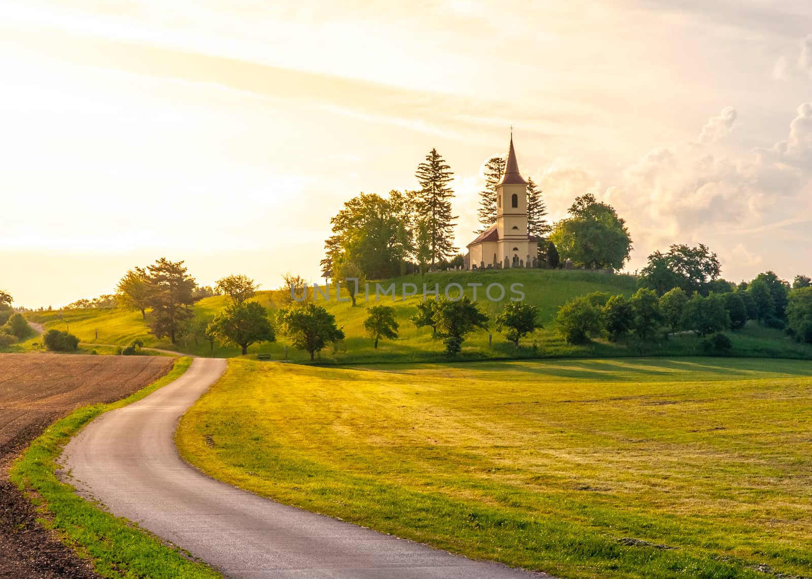 Small church in the middle of lush green spring landscape on sunny day. St. Peter and Pauls church at Bysicky near Lazne Belohrad, Czech Republic by pyty