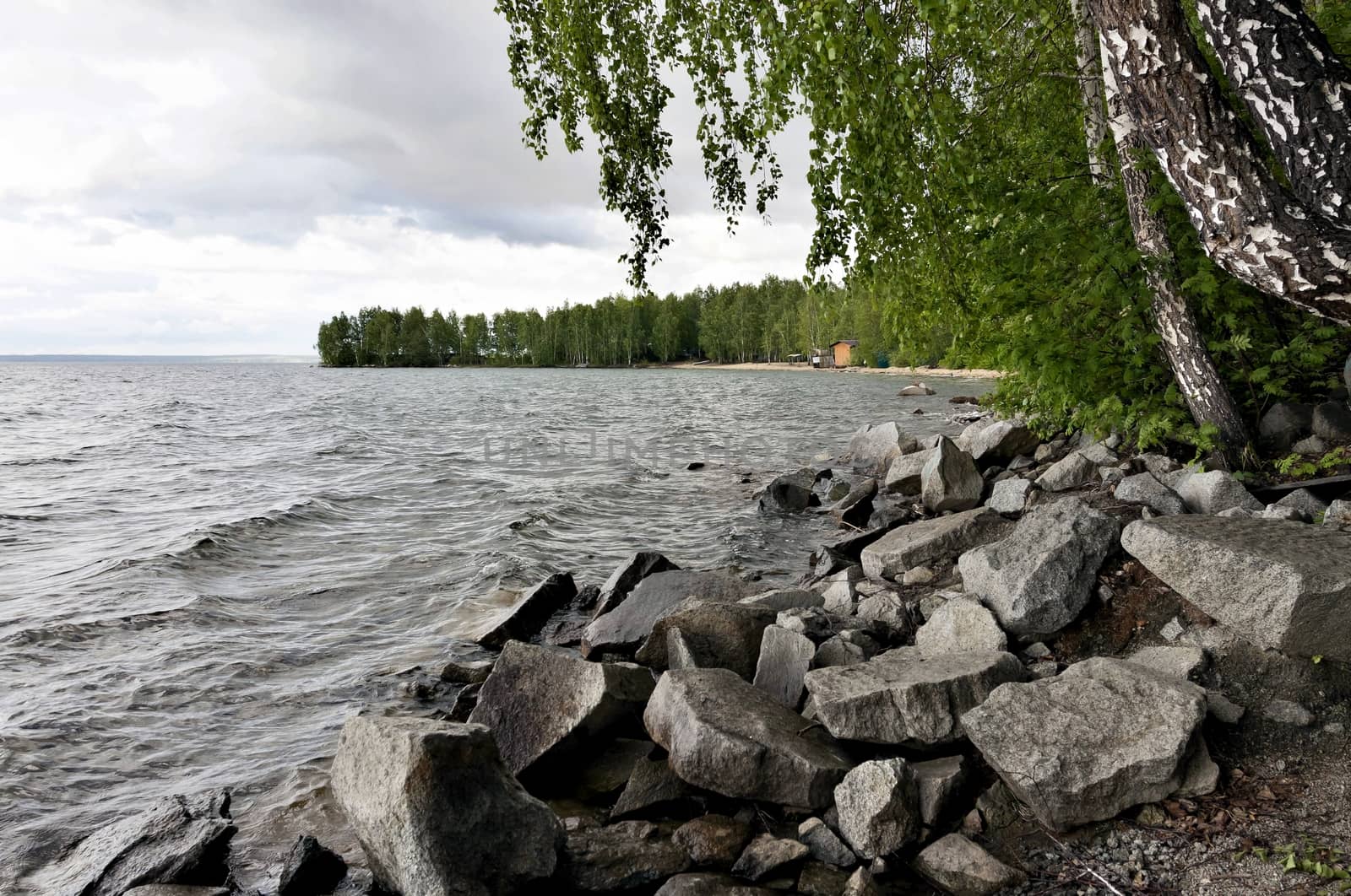 rocky shore of the lake, birch in the foreground, the southern Urals, lake Uvildy