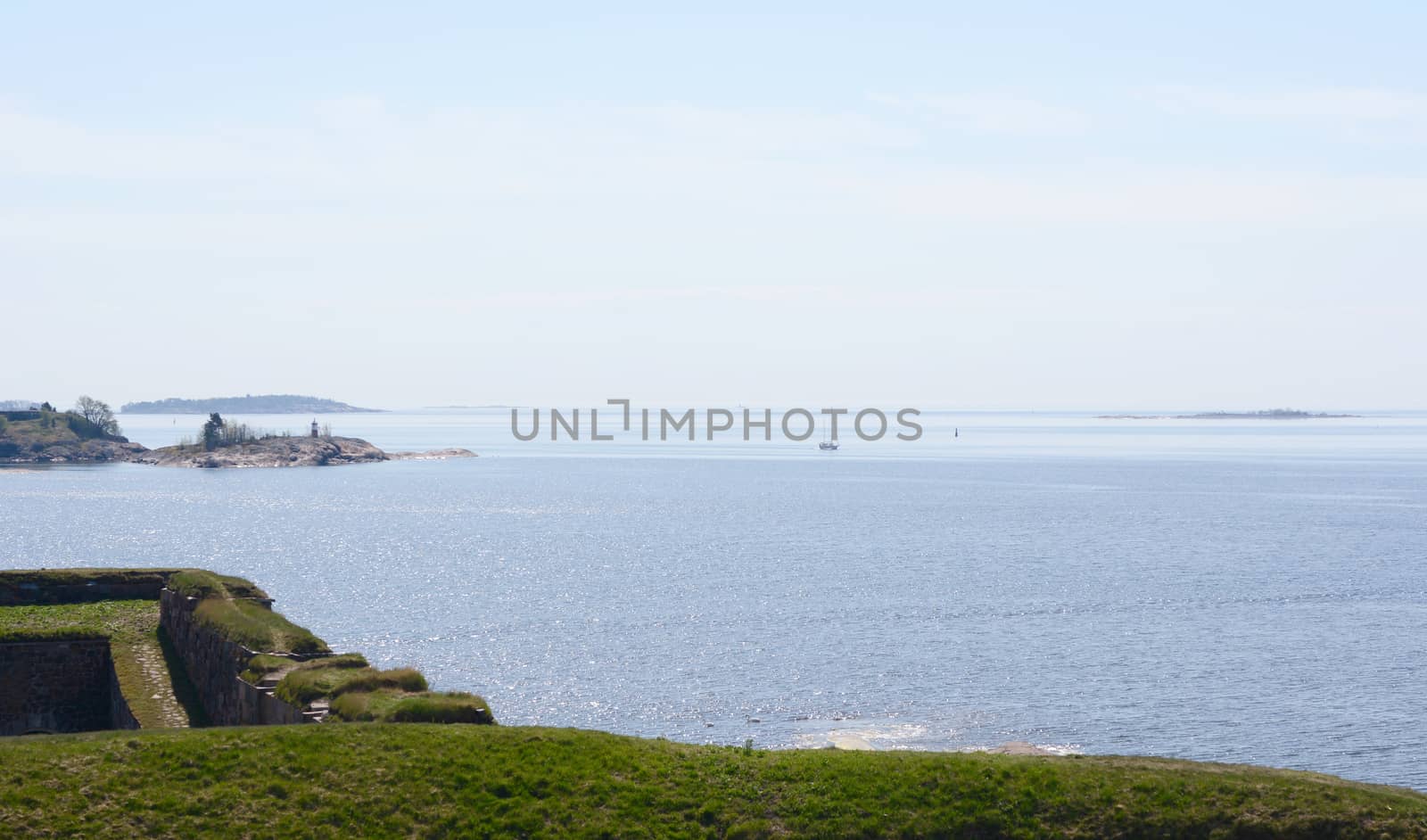 View from grassy hillside across Finnish waters from sea fortress Suomenlinna, Finland