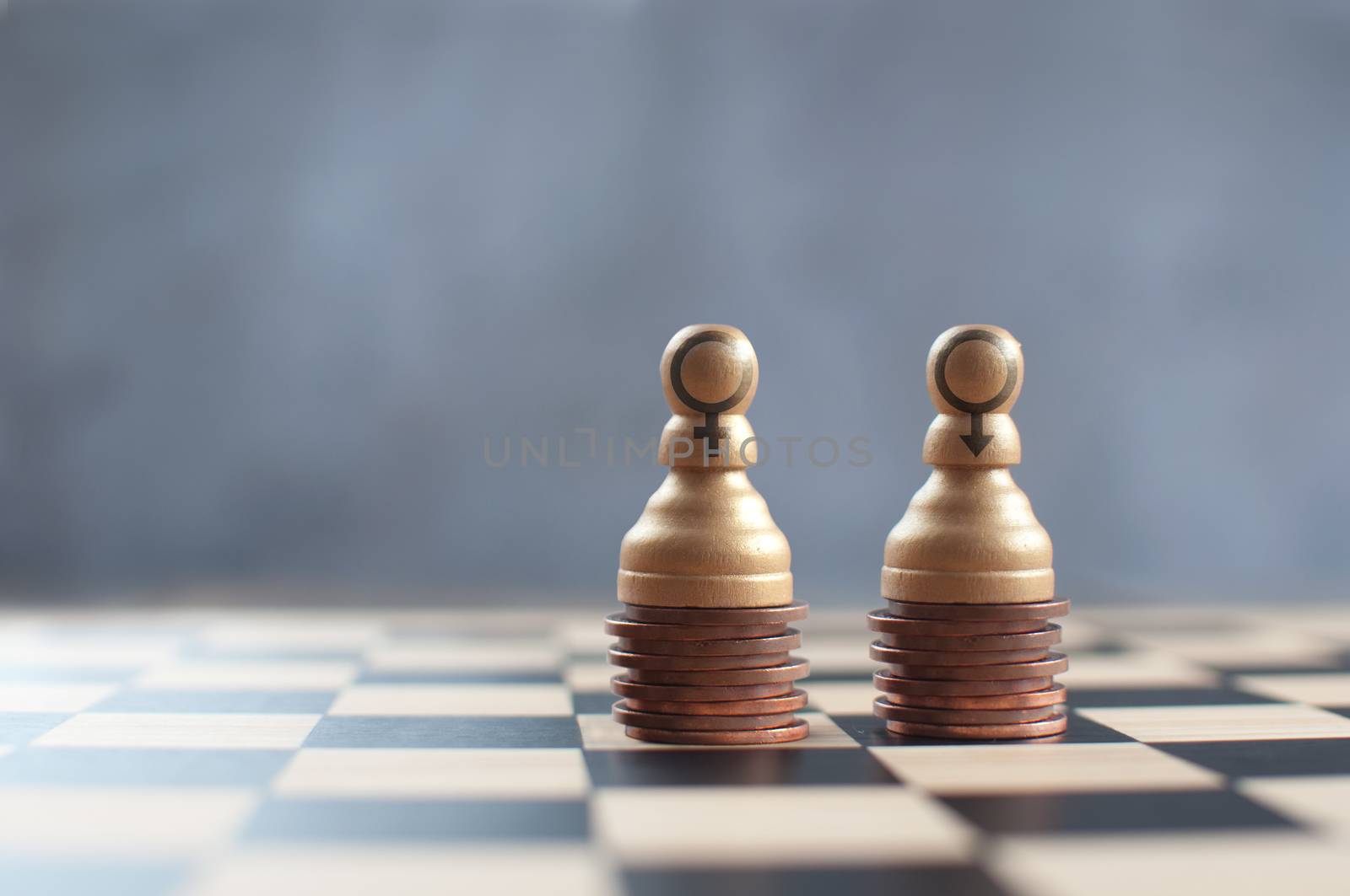 Two chess pawns on top of a heap of coins with varying heights 